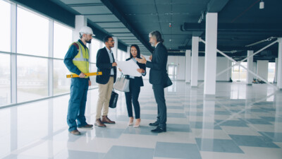 Real estate investors reviewing building plans