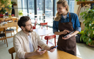 waitress using tablet to take order for customer
