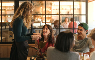 Group of friends ordering food in a bistro