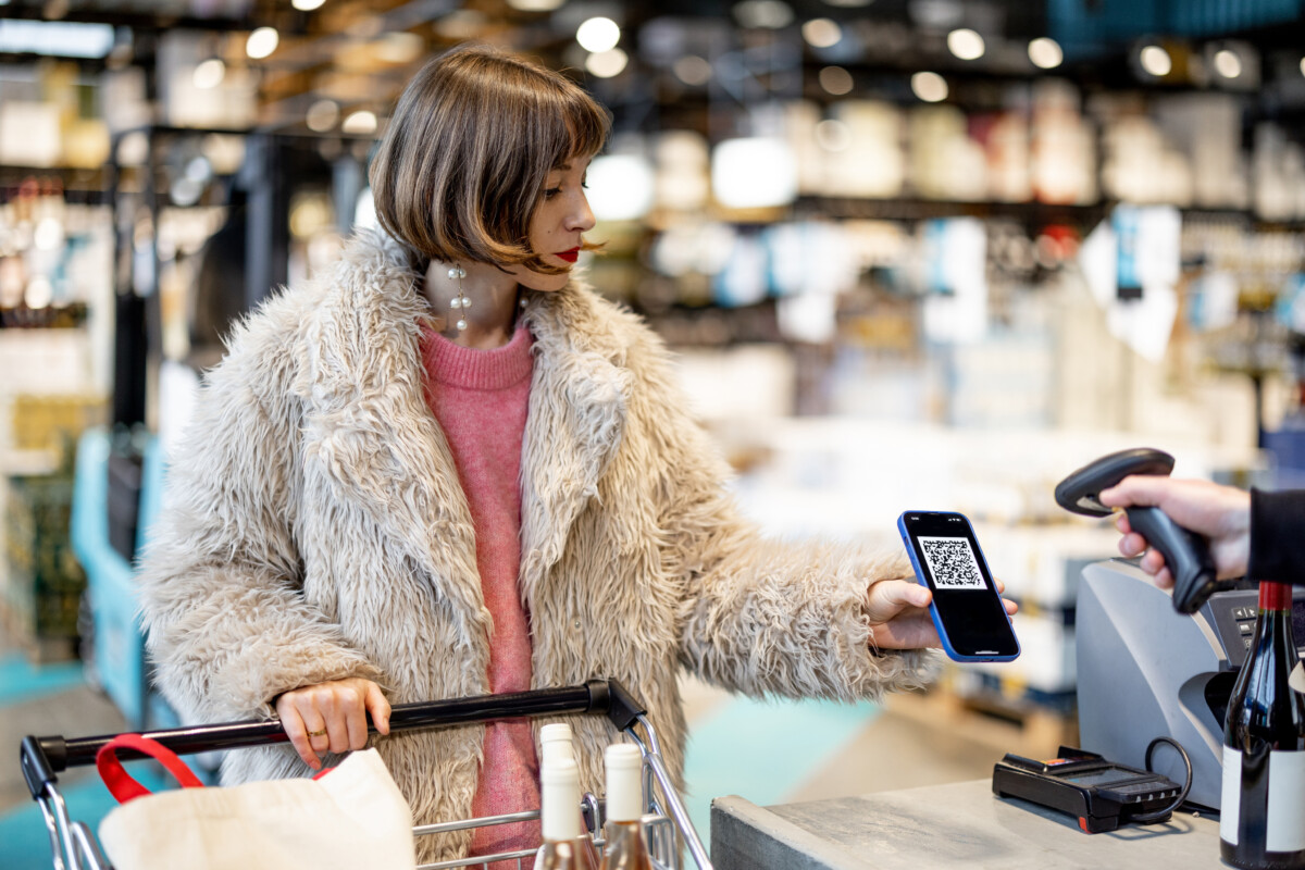Woman scanning loyalty QR at checkout