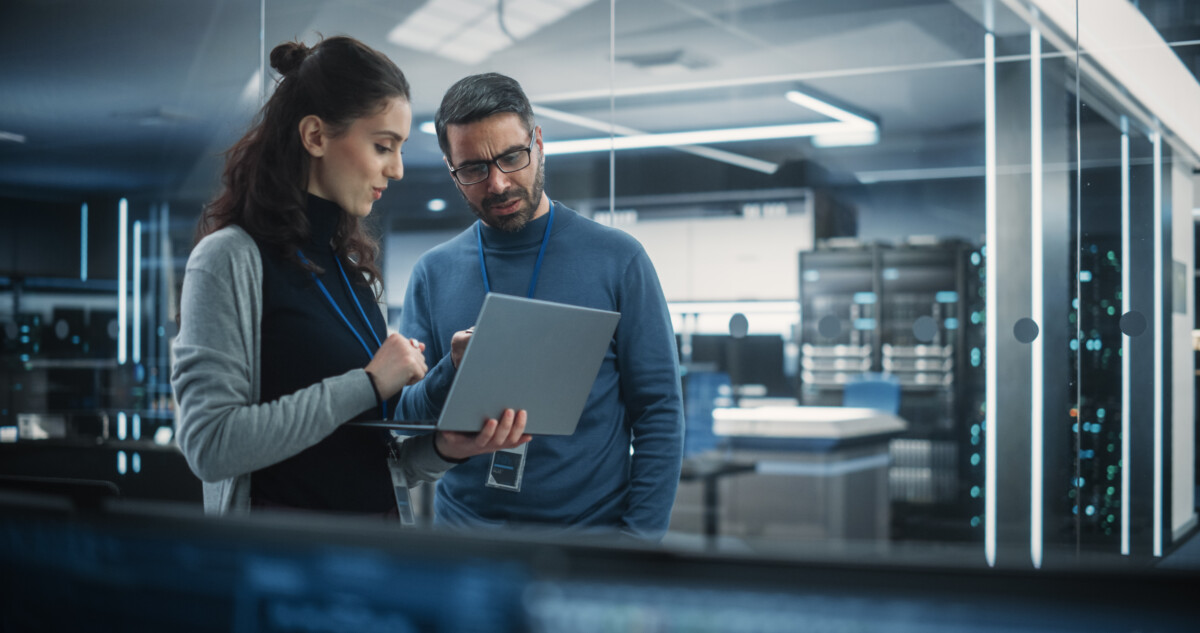 Coworkers Using Laptop in data center