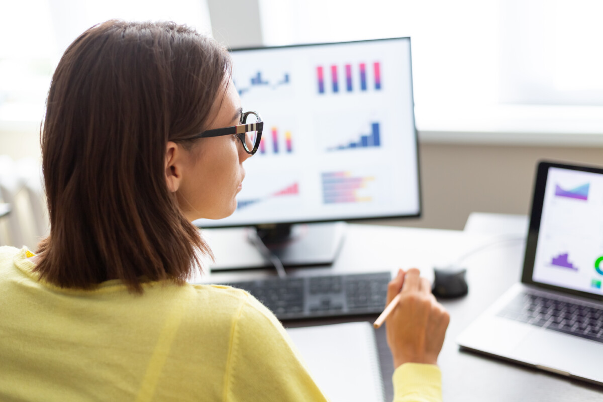 woman with data dashboard graphs