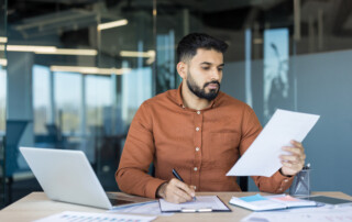 Businessman doing paperwork in office