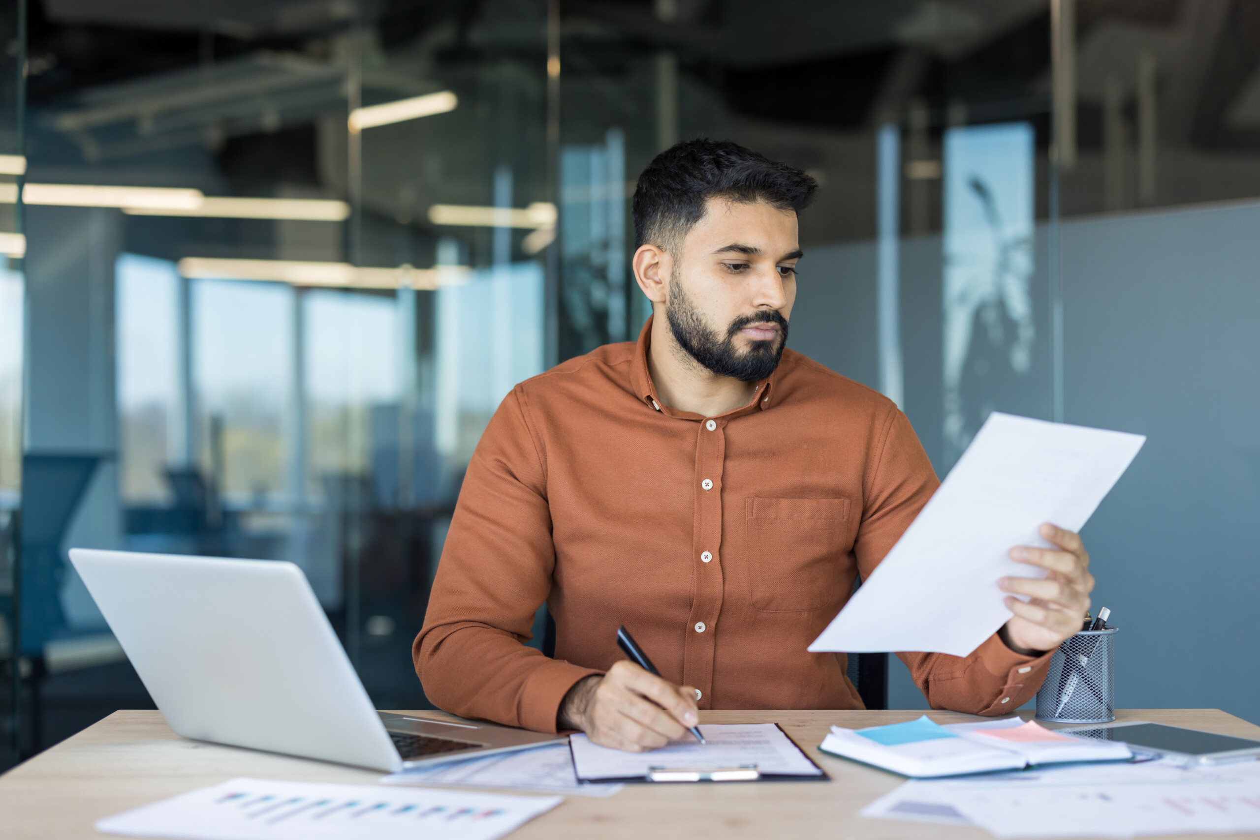 Businessman doing paperwork in office
