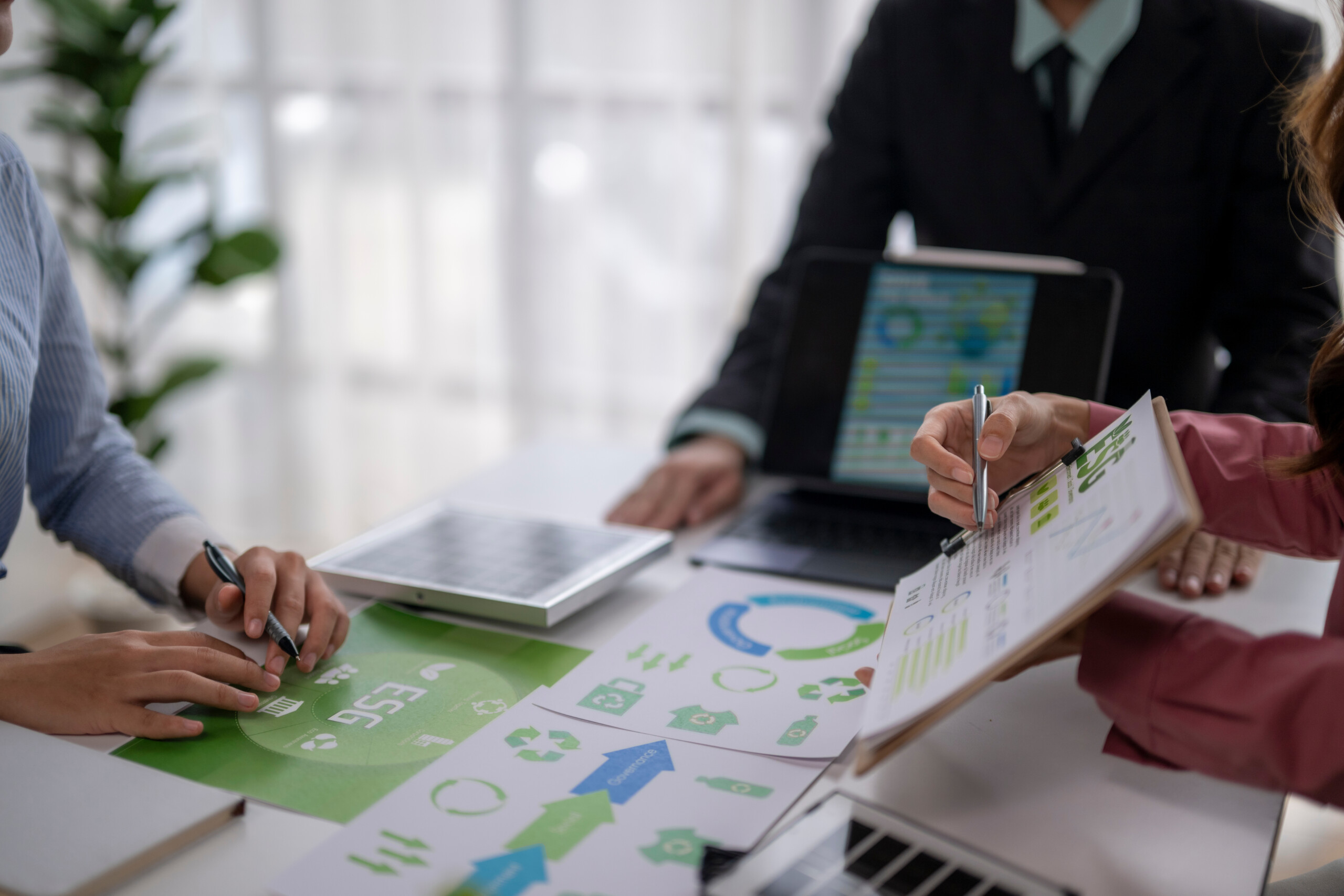 Business team analyzing esg sustainability data charts