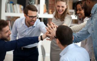 Excited motivated team give high five in office