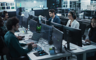 Team of Six Software Developers Working on Computers Programming