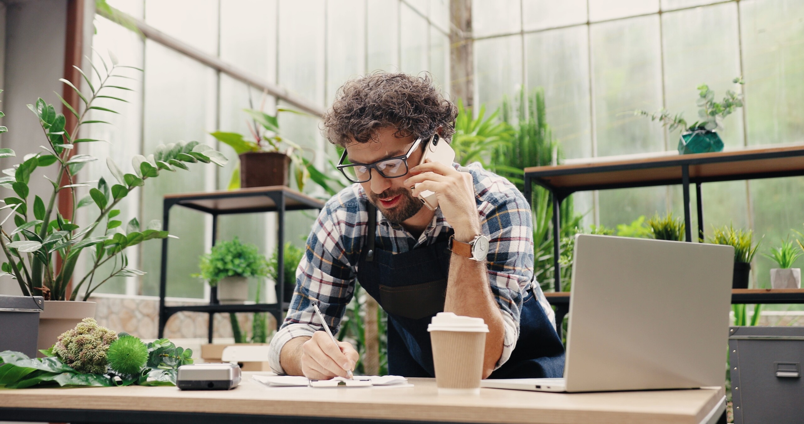 male florist calling on smartphone at work Own business concept