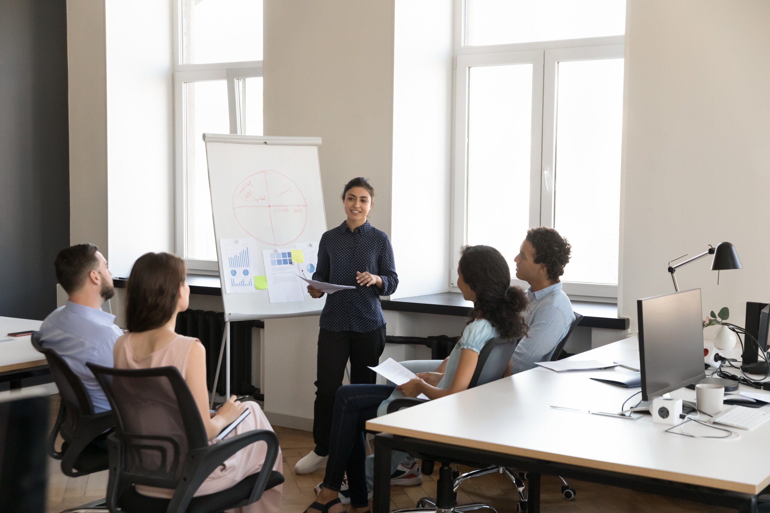 Team meeting on office listening to project leader report