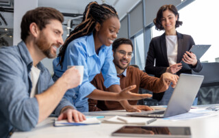 Group of businesspeople using laptop while working together