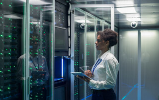 Female technician works on a tablet in a data center