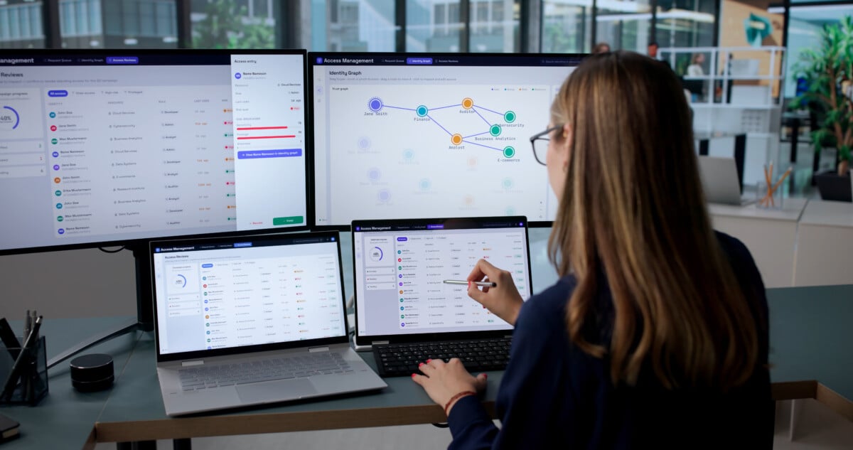 Woman Using Laptop To Manage User Access With Multi-factor Authentication.