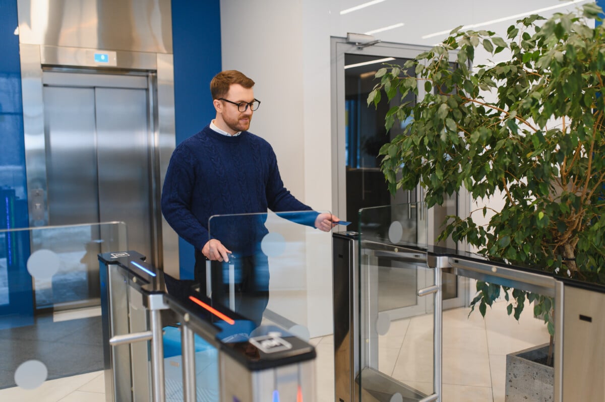 Employee accessing secure office building turnstile system