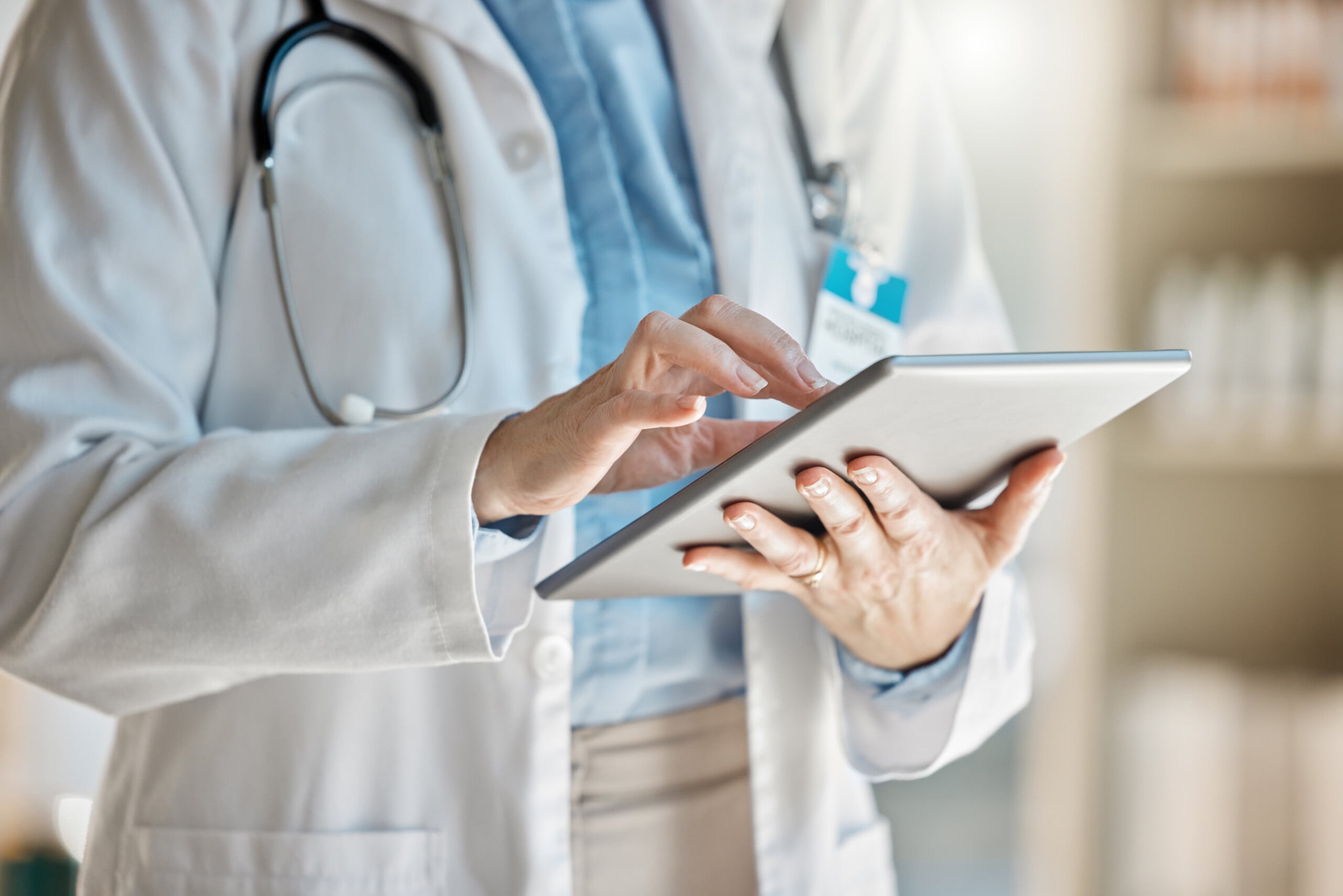 Doctor, office and tablet for research, email or communication.