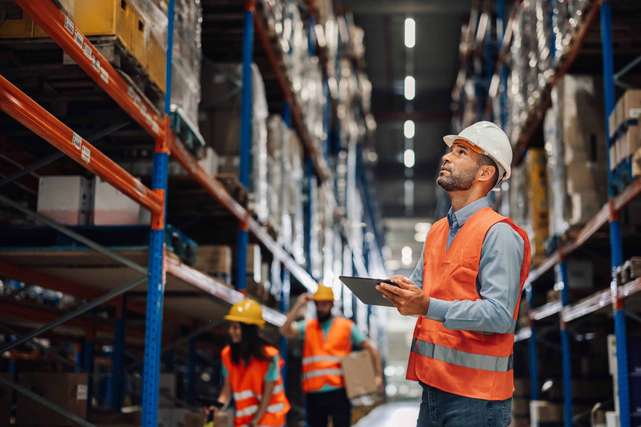 Warehouse manager using digital tablet checking inventory