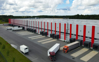 Aerial view logistics center with trucks loading cargo