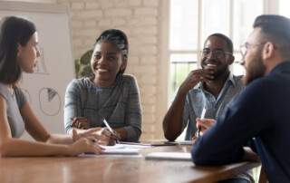 Employees listening ceo at group meeting