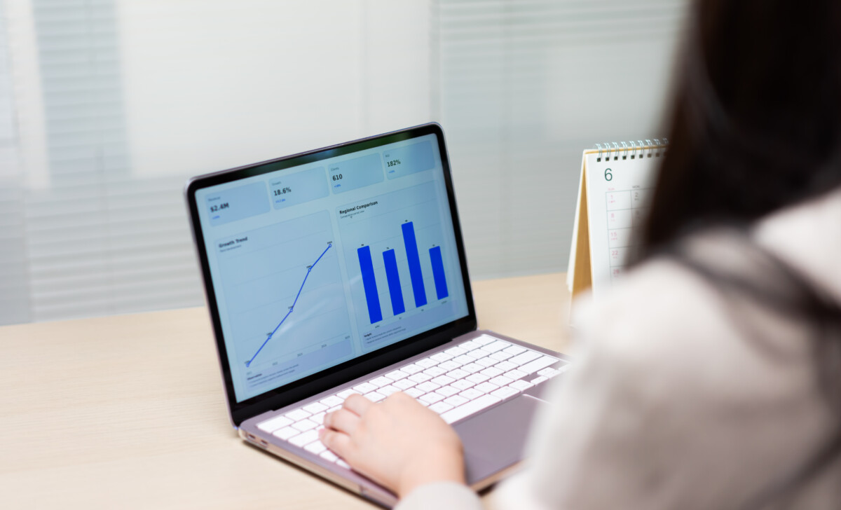 Businesswoman analyzes financial performance dashboards on laptop, reviewing growth charts and revenue reports to support strategic planning, productivity tracking, and data driven business decisions.